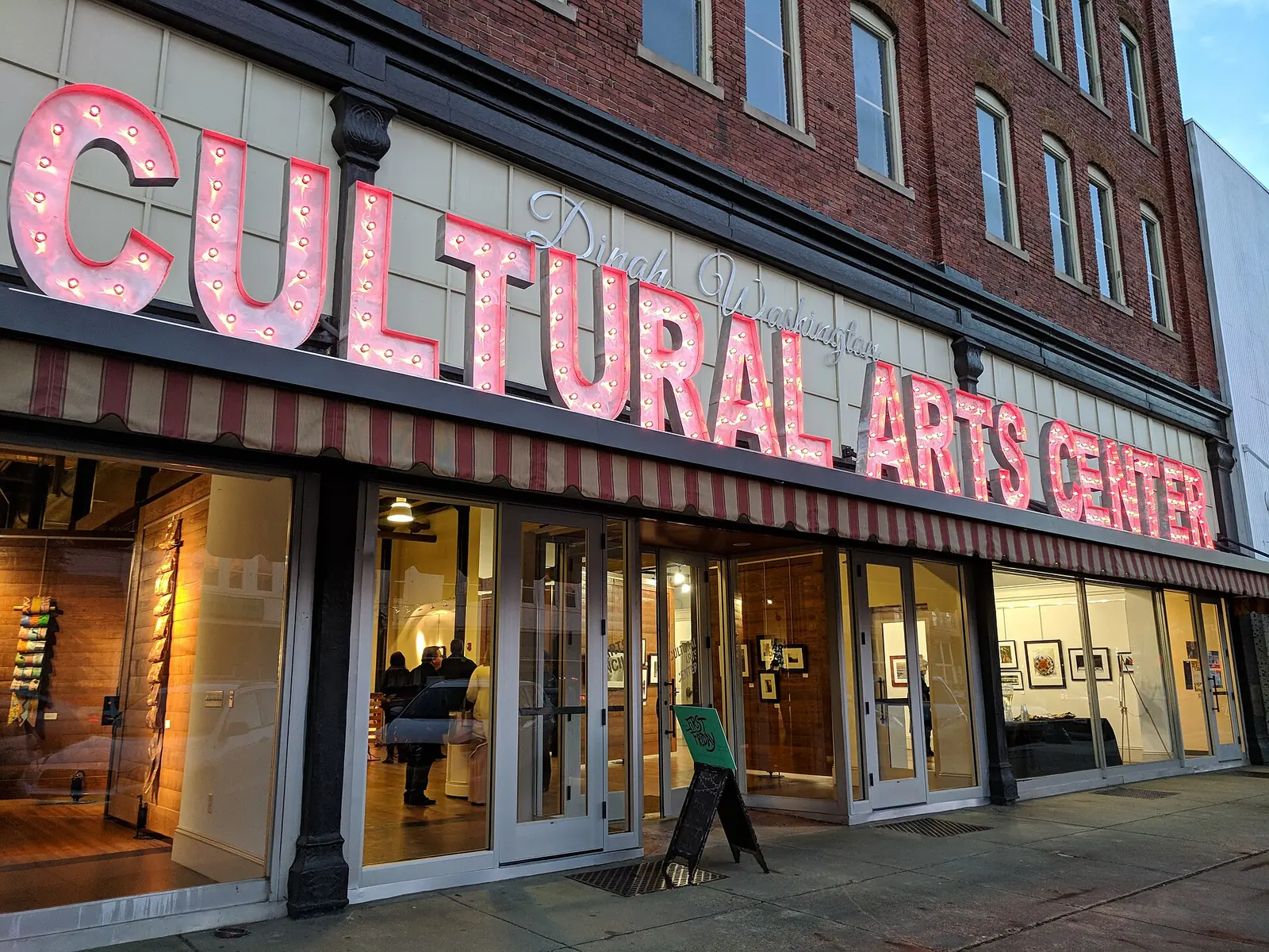 The lit marquee letters of the Dinah Washington Cultural Arts Center on Greensboro Avenue in downtown Tuscaloosa, home of the Arts Council Gallery.