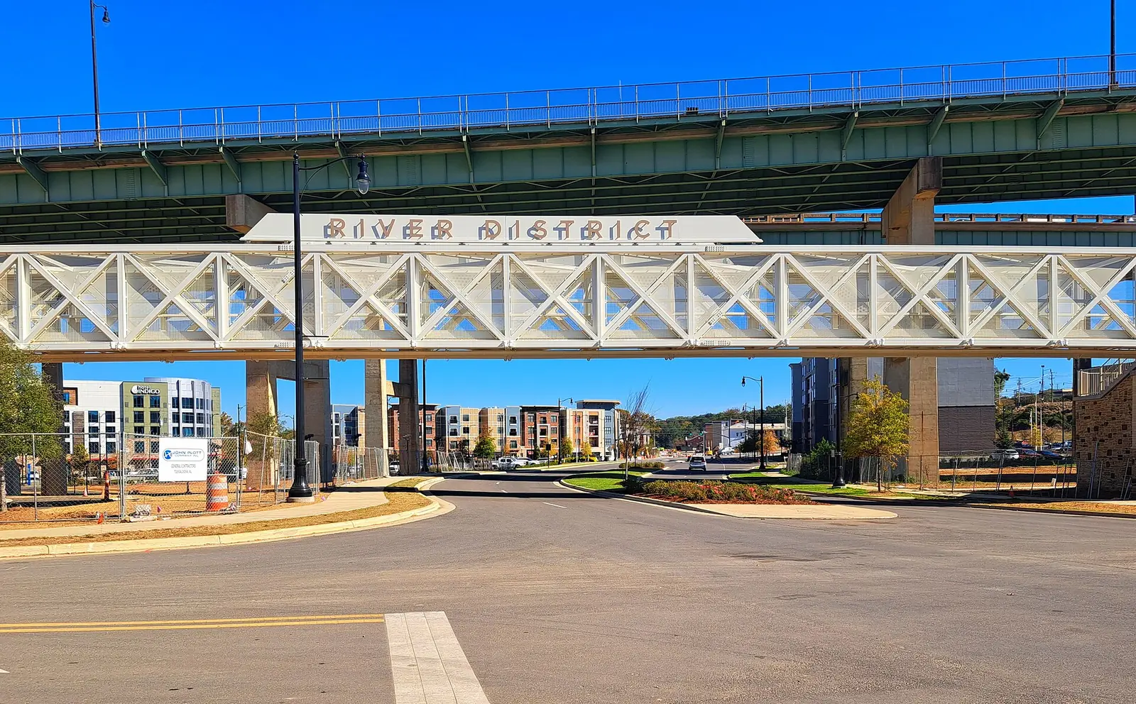 The River District sign on the pedestrian bridge at the entrance to downtown Tuscaloosa's riverfront district.