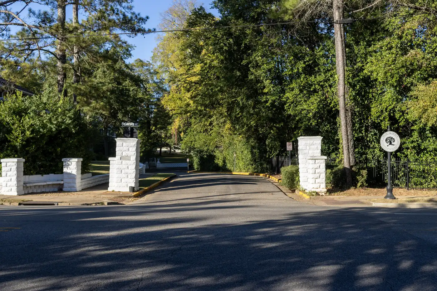 White stone gateposts and a city historic district marker stand at the entrance to the Pinehurst Historic District in Tuscaloosa.