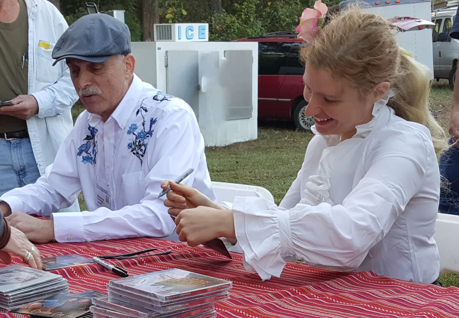 Folk musicians Jim Kweskin and Meredith Axelrod sign CDs for fans at the Kentuck Festival of the Arts.