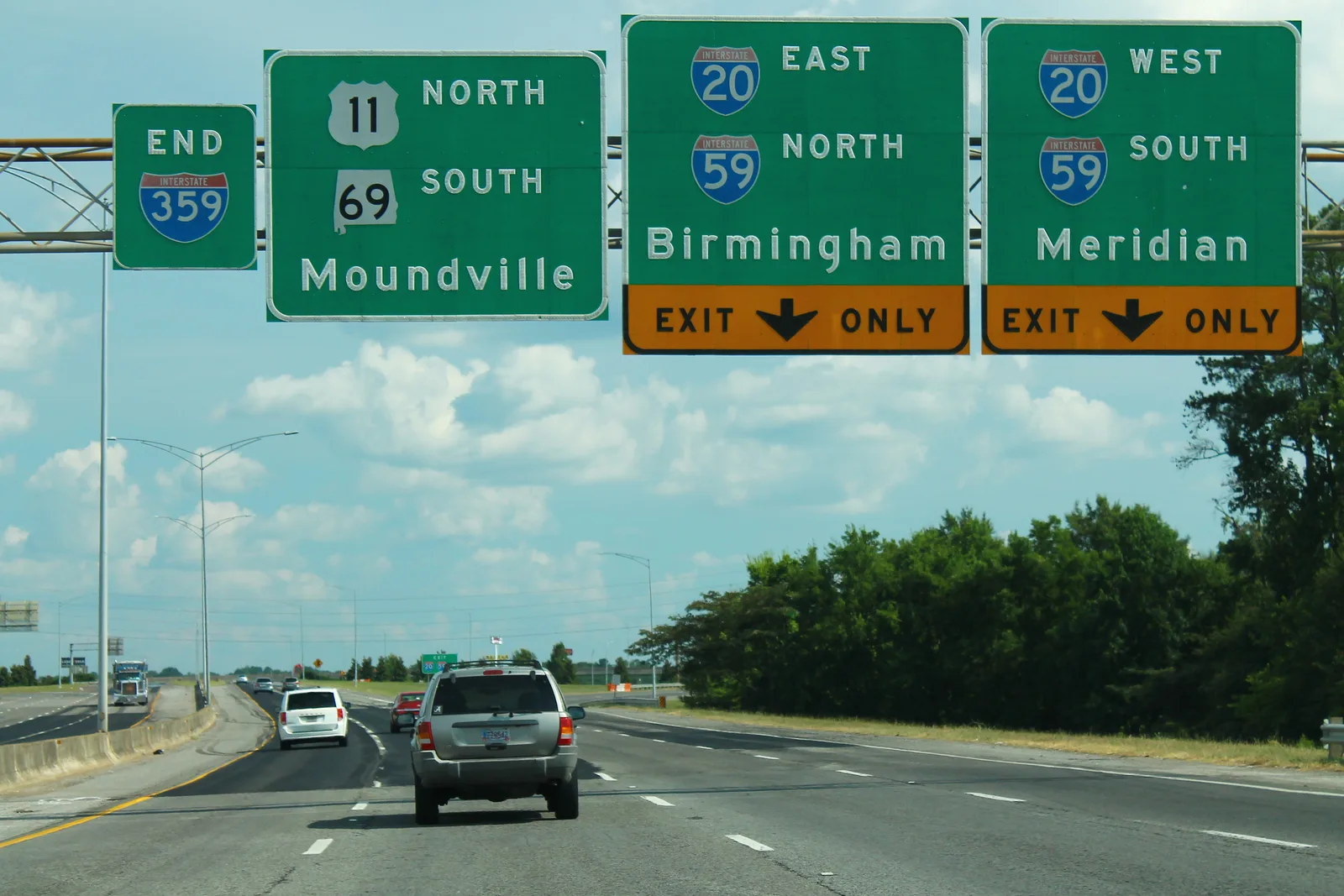 Overhead signs mark the end of Interstate 359 at the I-20/59 interchange, with lanes for Birmingham and Meridian, in Tuscaloosa.