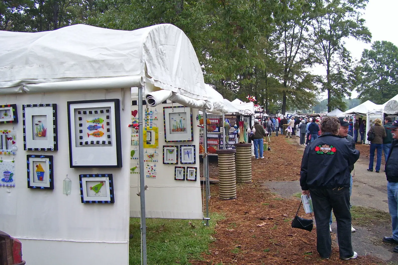 Visitors walk a row of artists' tents at the Kentuck Festival of the Arts in 2006, when the festival was held at Kentuck Park in Northport.