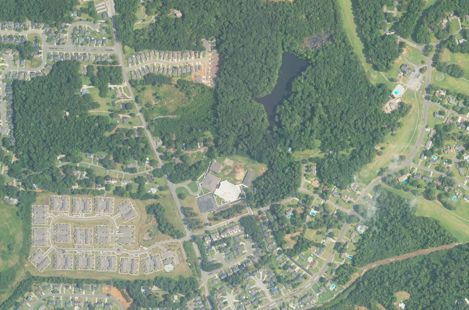 Aerial view of Woodland Forrest Elementary School and the wooded subdivisions around it in southeast Tuscaloosa.