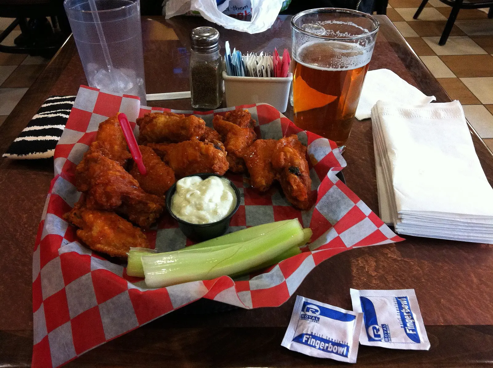A basket of Buffalo wings with celery and blue cheese at the Anchor Bar at the airport in Buffalo, N.Y.